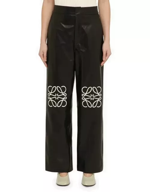 Black leather baggy trousers with logo
