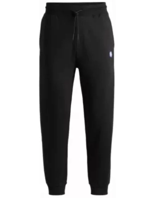 Cotton-terry tracksuit bottoms with smiley-face logo patch- Black Men's Jogging Pant