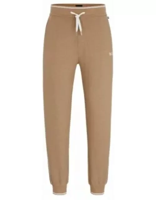 Piped tracksuit bottoms with embroidered logo and drawstring waist- Beige Men's Loungewear