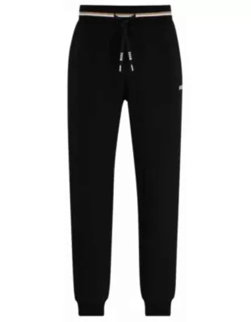 Tracksuit bottoms with stripes and logos- Black Men's Loungewear