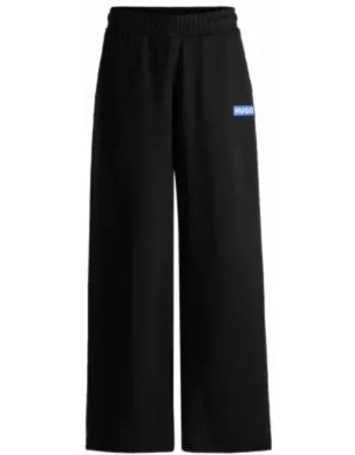 Relaxed-fit tracksuit bottoms with logo print- Black Women's Clothing