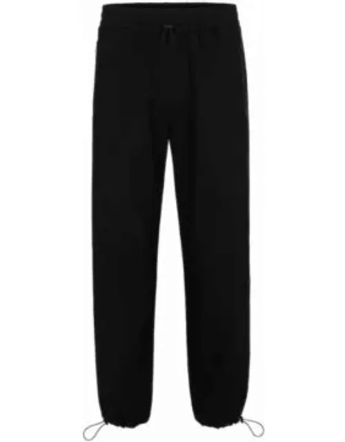 Water-repellent trousers with adjustable hems- Black Men's Casual Pant