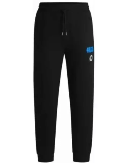Cotton-terry tracksuit bottoms with smiley-face logo- Black Men's Jogging Pant