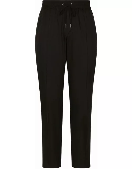 Black sports trousers with logo plaque