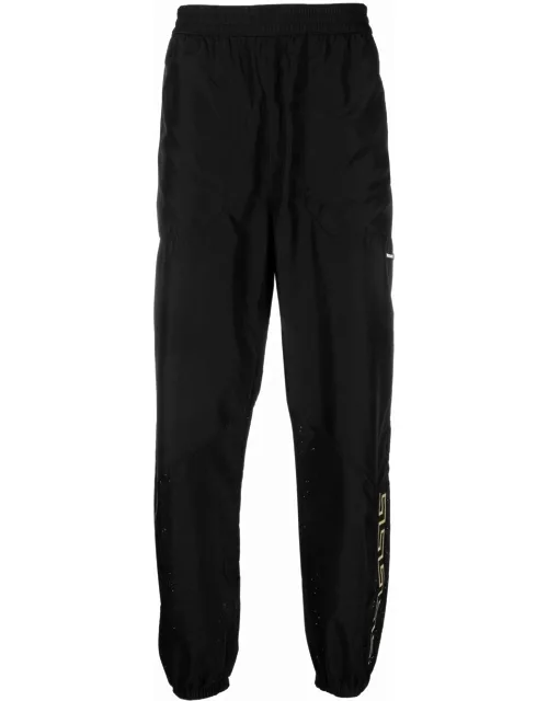 Black sports trousers with La Greca print