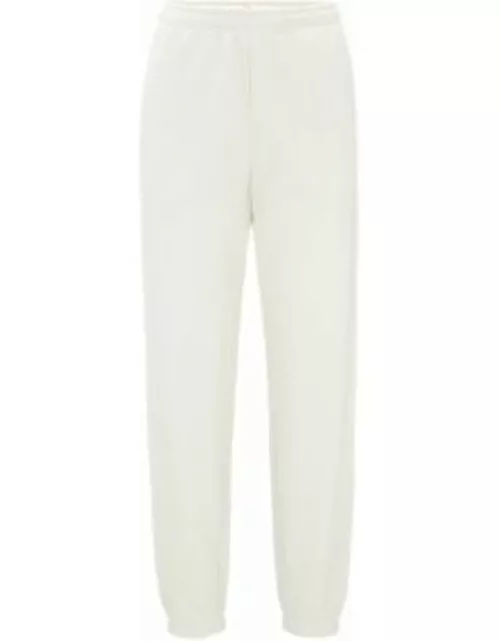 Relaxed-fit tracksuit bottoms with embossed stacked logo- White Women's New To Sale