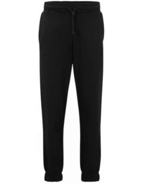 Relaxed-fit cotton-terry tracksuit bottoms with stacked logo- Black Men's Jogging Pant