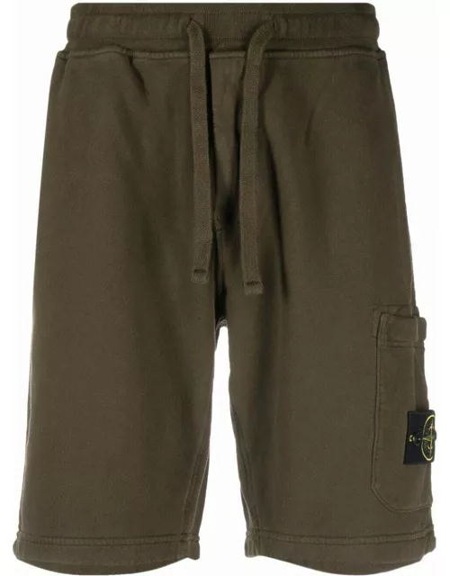 Green sports shorts with Compass logo applique