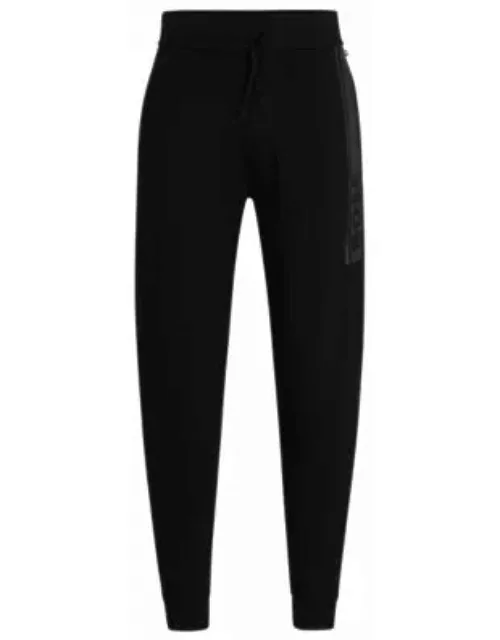 Cuffed tracksuit bottoms in French terry with logo print- Black Men's Loungewear