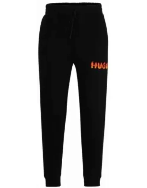 Cotton-terry tracksuit bottoms with puffed flame logo- Black Men's Jogging Pant