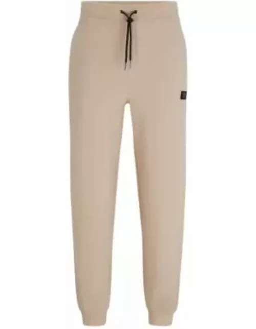 Stretch-cotton tracksuit bottoms with stacked logo- Beige Men's Jogging Pant