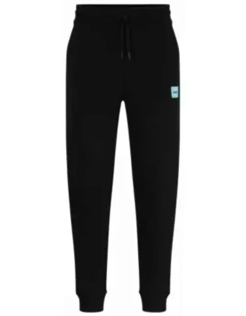 Cotton-terry tracksuit bottoms with red logo label- Black Men's Jogging Pant