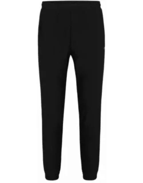Tracksuit bottoms in stretch fabric with decorative reflective logo- Black Men's Jogging Pant
